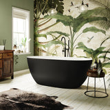 The Audsley freestanding stone bath with black exterior with matt black freestanding bath taps.