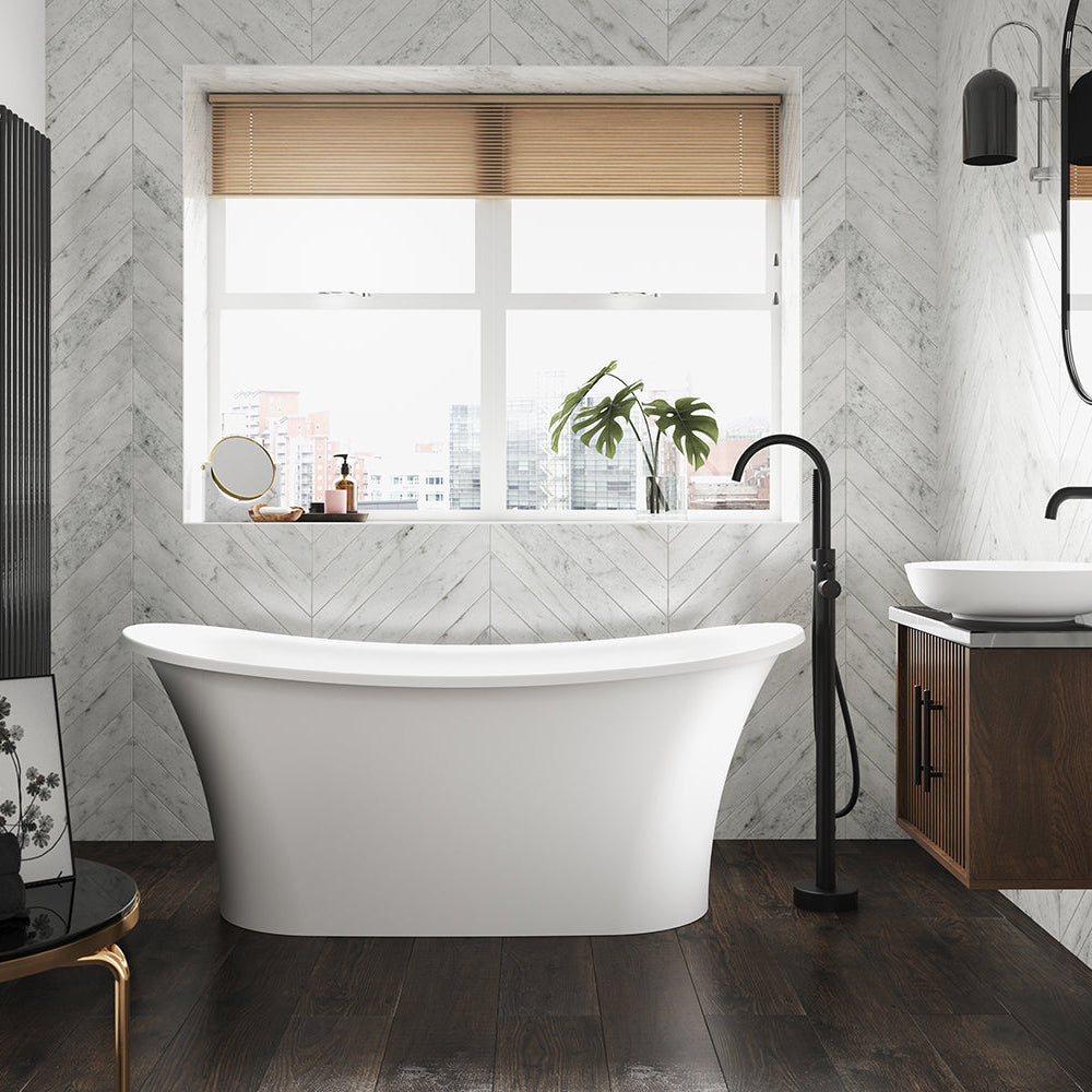 The Goldsmith stone freestanding bath in a modern bathroom with matt black freestanding bath taps.
