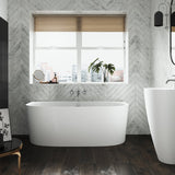 The Lawrence stone back to wall bath in a modern bathroom with the Marlow freestanding basin.