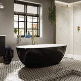 The Lowry freestanding stone bath with black exterior with brushed brass brassware.