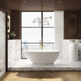 The Nash stone teardrop freestanding bath in a luxury London bathroom with brushed brass freestanding bath taps.