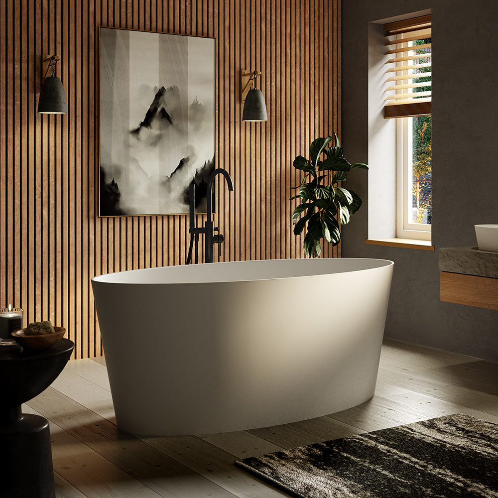 The Temper freestanding stone bath with matt black freestanding bath taps.
